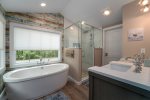 Ensuite Master Bathroom with Dual Sinks, Soaking Tub, and Shower